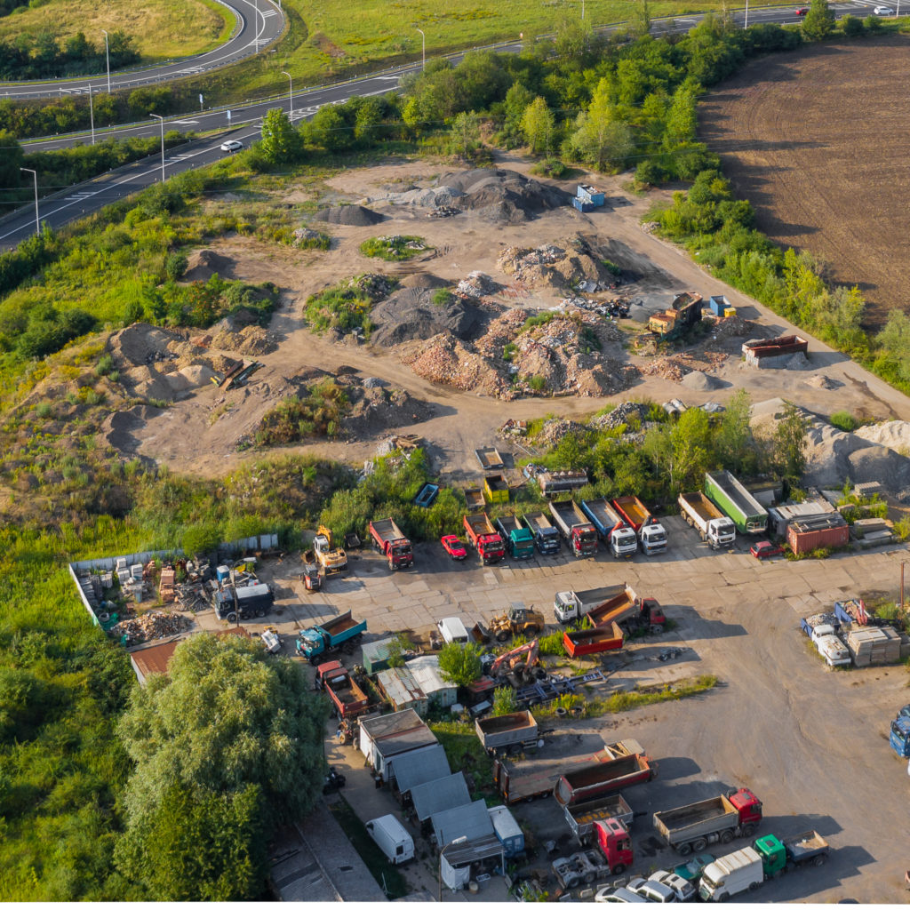 Aerial View of Trucks and Vehicle Parking Near Landfill