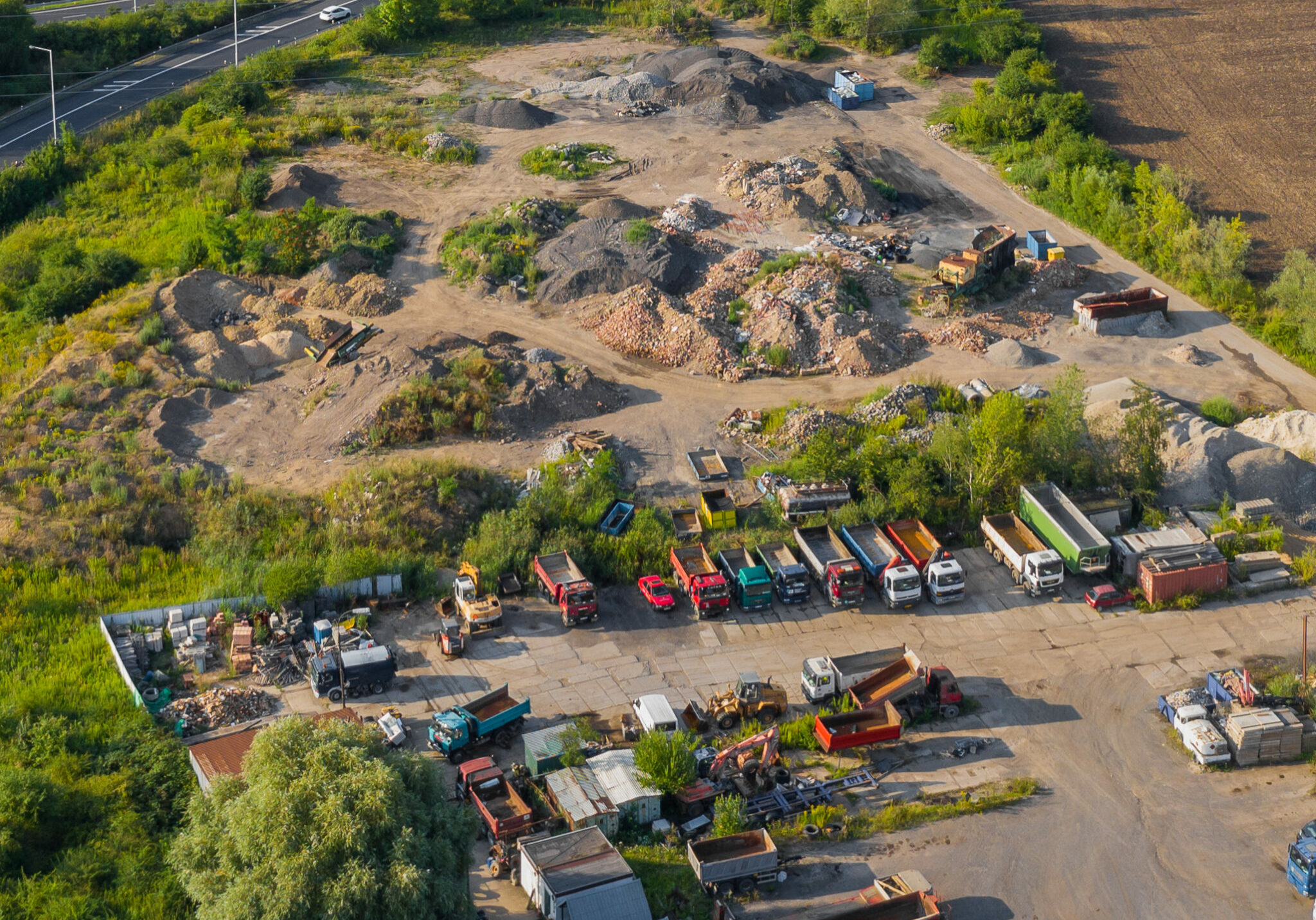 Aerial View of Trucks and Vehicle Parking Near Landfill